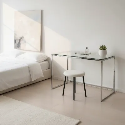 Sleek glass vanity table in a minimalist, modern bedroom with ample natural light
