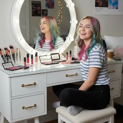 A teen girl happily organizing her makeup collection on a clean, white vanity table with built-in drawers and a bright mirror.